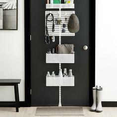 a black door with white shelves holding various items