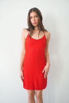 Shine on. This luxurious & stunning slip dress is mini-length and is fully hand-beaded by women artisans in Bali. Perfect for a night out or special occasion, you'll be sure to dance 'til dawn in this dress. Features adjustable back crisscross straps and an invisible back zipper. Also available in White. Ethically handcrafted from luxurious sustainable fabrics certified Oeko Tex Standard 100.1% of your order funds regenerative carbon offsets How it Fits Product Details Fabric & Care Fits true to