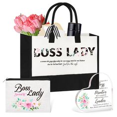 a white bag with pink flowers in it next to a black and white gift bag