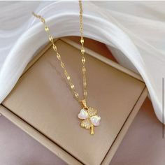 Lucky Four Clover Necklace For Women Stainless Steel Flower Pendant Golden Color Necklaces Fashion Perfect For Weddings, Special Occasions, Or As A Thoughtful Gift For Loved Ones White Flower Pendant Necklace With Clavicle Chain, White Flower Clavicle Chain Necklace, Feminine White Flower Necklace For Gift, Feminine White Flower Necklace As Gift, Elegant White Flower-shaped Necklaces, White Feminine Necklace With Flower Charm, Feminine White Necklace With Flower Charm, Feminine White Flower Charm Necklace, White Flower Necklace For Mother's Day