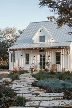 a white house with a stone path leading to it