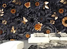 a living room filled with furniture and a large wall mural covered in black paper flowers