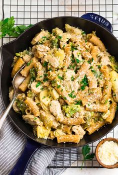 a skillet filled with pasta and chicken