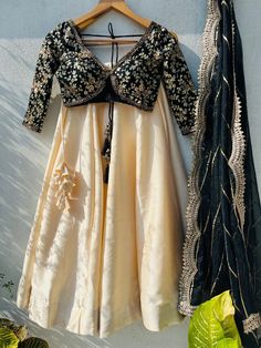 🖤Black And Beige Sabyasachi Lehenga Set. Black sharmily blouse with bold cuts and elegant embroidered in sequin, zardozi and with contrasting beige silk lehenga. and dupatta is in organza with sequin work highlight and scallop edging. This lehenga set can be made in Your Choice COLOR combo. Please message us if you want this in a different color. Blouse: Sequins, zardosi, and embroidery on black Raw Silk fabric. Lehenga: Art raw silk fabric Dupatta: Organza fabric Our products are 100% authenti Unstitched Blouse Wedding Sets For Diwali, Wedding Sets With Unstitched Blouse For Diwali, Anarkali Wedding Sets With Unstitched Blouse, Wedding Sets With Unstitched Blouse For Eid, Saree Set With Unstitched Blouse For Wedding, Transitional Dori Work Reception Dress, Transitional Reception Dress With Dori Work, Art Silk Cutdana Dress For Reception, Silk Saree Gown With Dori Work