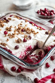 a close up of a dessert in a pan with cranberry sauce and nuts