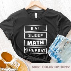 a t - shirt that says eat sleep math repeat on it next to some shoes