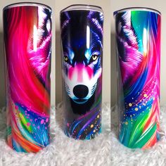 three colorful tumbles with an image of a wolf on one side and another animal on the other