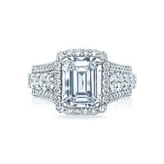 an emerald - cut diamond ring set in 18k white gold with pave diamonds