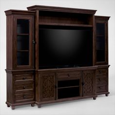 a large entertainment center with drawers and a flat screen tv mounted on it's side