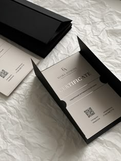 two black and white business cards in a box