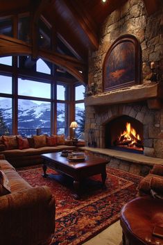 a living room with couches and a fire place in the middle of the room