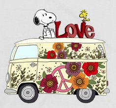 a dog is sitting on top of a vw van with flowers and the word love