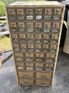 an old wooden filing cabinet with many drawers