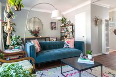 a living room filled with furniture and lots of plants