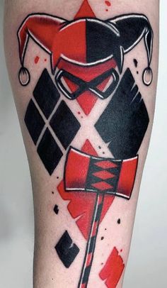 a person with a red and black tattoo on their leg is holding a knife in his hand