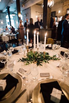 the table is set with candles and place settings