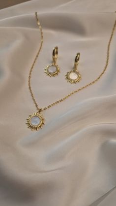 Elevate your wedding day style with our exquisite boho jewelry set. Featuring a stunning celestial pendant chain necklace and elegant gold plated sun earrings, this collection is designed for the modern bride who loves bohemian charm. Each piece is crafted with meticulous attention to detail, blending celestial motifs with timeless elegance to create jewelry that is both unique and breathtaking. MATERIAL - 18 K gold plated brass, natural mother of pearl SIZE - standard size of the necklace - 45 White Delicate Jewelry Gift, White Ethereal Jewelry For Gifts, White Celestial Clavicle Chain Jewelry, Gold Bohemian Jewelry Sets For Wedding, Celestial Style White Clavicle Chain Jewelry, Celestial White Clavicle Chain Jewelry, White Celestial Choker Jewelry, Bohemian Gold Jewelry Sets For Wedding, Bohemian Rose Gold Jewelry For Wedding