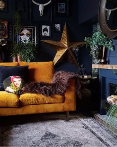 a living room filled with lots of furniture and pictures on the wall next to a fire place