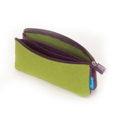 a green and purple zippered pouch sitting on top of a white table