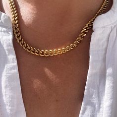 This gold plated Cuban link chain necklace has a simple but bold appeal. Crafted from stainless steel and plated with a thick 18k gold layer, the chain has tighter interlocking links than a classic curb chain. The necklace makes an ideal base for mix and matching with other chains and pendant necklaces or can be worn solo for an understated look.  ▪️Gold plated stainless steel ▪️7mm wide chain ▪️Lobater clasp ▪️Choose your length ▪️The neckla will be presented in attractive Scraffs packaging Trendy Gold Cuban Link Necklace, Gold Plated Curb Chain Link Necklace, Trendy Gold Cuban Link Chain Necklace, Cuban Link Necklace As A Gift, Trendy Gold Curb Chain Necklace, Chunky Cuban Link Necklace Gift, Gold Cuban Link Necklace Minimalist Style, Trendy Cuban Link Gold Chain Necklace, Cuban Link Necklace With Cable Chain As A Gift