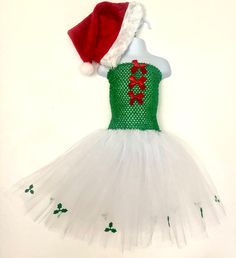 🎄 Beautiful girl's, Christmas themed tutu dress.  🎄Handmade, fluffy tutu dress with white tulle skirt and Holly edging detail.  Green elasticated body with red bow detail to front.  Comes with a matching Santa hat.  A fun, seasonal addition to any girl's wardrobe.  🎄Suitable for child 2-7 years of age, but can do, larger if required.  🎄Beautiful, bespoke, delicately handmade, child's tutu. All tulle used has been tested and conforms to EU safety standards, EN 71-2 flammability and EN 71-3 Mi White Tulle Skirt, Christmas Tutu, Xmas Dress, Santa Dress, Kids Tutu, Dress Tutu, White Tulle, Girls Wardrobe, Beautiful Skirts