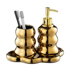 a gold bathroom set with a toothbrush holder