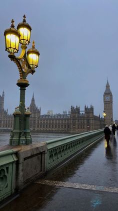 people are walking on the bridge near big ben