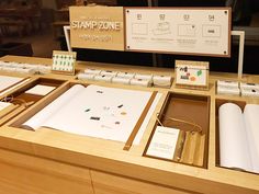 some papers are sitting on top of a wooden table with other items in the drawer