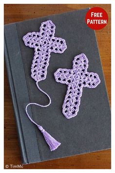 two crocheted crosses sitting on top of a book