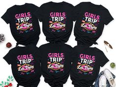 four girls trip t - shirts with the words girls trip printed on them, surrounded by other items