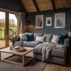 a living room filled with furniture next to a large glass door leading to a lush green field