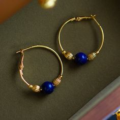 Golden ring earrings made of beautiful blue gemstone lapis lazuli. The round shape of lapis lazuli looks like a blue comet floating in space. You will be drawn into its mysterious beauty. It has a retro atmosphere that is timeless. 
 
 
 Type 
 
 Earrings 
 
 
 Size 
 
 Diameter: 3.0cm 
 
 
 Material 
 
 Alloy 
 Natural blue goldstone 
 
 
 Others 
 
 If you have a metal allergy or the plating does not suit your skin, please refrain from ordering. Blue Hoop Brass Jewelry, Blue Brass Hoop Jewelry, Royal Blue Lapis Lazuli Round Jewelry, Royal Blue Lapis Lazuli Jewelry, Royal Blue Round Lapis Lazuli Jewelry, Blue Brass Round Jewelry, Blue Round Brass Jewelry, Elegant Blue Circular Jewelry, Pierced Lapis Lazuli Round Jewelry