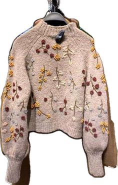 Winter Embellished Long Sleeve Cardigan, Beige Long Sleeve Sweater With Floral Embroidery, Long Sleeve Embellished Cardigan For Winter, Embellished Long Sleeve Cardigan For Winter, Knit Tops With Floral Embroidery For Fall, Floral Embroidery Knit Tops For Fall, Winter Embroidered Knit Tops, Casual Winter Sweater With Floral Embroidery, Embroidered Knit Long Sleeve Sweater