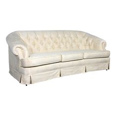 a white couch sitting on top of a wooden floor