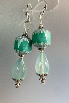 The gorgeous faceted chalcedony teardrops are the inspiration for these earrings. I paired them with equally stunning Czech Glass Cathedral beads. To set them off I added tiny seed beads and bead caps. Lightweight, elegant and eye catching! Czech Glass Beads are known for their durability and high quality. Chalcedony is a stone of balance and can bring your body, mind and spirit into harmony.  WEAR IN GOOD HEALTH! Turquoise Teardrop Earrings With Faceted Beads, Jade Beaded Earrings For Jewelry Making, Elegant Jade Beaded Earrings, Turquoise Teardrop Faceted Beads Jewelry, Green Teardrop Czech Glass Jewelry, Green Czech Glass Teardrop Jewelry, Green Beaded Dangle Teardrop Earrings, Turquoise Teardrop Faceted Earrings, Turquoise Faceted Teardrop Earrings