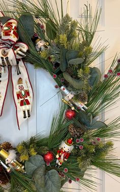 a christmas wreath with nutcrackers and pine cones