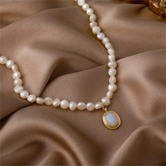 Make every day an opportunity for elegance with this pearl choker featuring a glossy framed pendant. Chain : 14.96" L with 2.76" extender Pendant : 0.35" W x 0.55" L Lobster claw clasp 18k gold-plated copper / pearl / blue resin White Oval Pearl Pendant Necklace, Oval Pearl Pendant Jewelry In Pearl White, Oval Pearl Necklace As Gift, Oval Pearl Necklace For Gift, Oval Pearl Necklace Gift, Pearl White Oval Necklace With Pearl Pendant, Pearl White Oval Necklace With Pearl Drop, Pearl White Oval Jewelry With Pearl Charm, Elegant Pearl Necklace With Oval Pendant For Gift