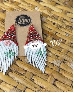 the beaded santa clause earrings are on display in front of a cardboard card that says you