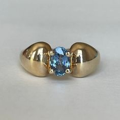 14K Gold CID Blue Topaz Stone Ring, Size 8, 4.6 grams, Clyde Duneier, Inc Size: 8 Weight: 4.6 grams Stones:  Blue Topaz Size Stone: ca. xxmm  Color Gemstone: Blue  Number of Gemstones: 1 Cut: Oval Markings: 14K, CID Maker: Clyde Duneier, Inc Bandwidth: ca. xxmm at smallest point  Tested: Tested with Mizar electronic gold tester ET18 (testing performed by 3rd person) Condition: Very good preowned with light usage throughout -refer to pictures for condition. All jewelry will be professionally clea Modern Yellow Gold Blue Topaz Ring, Yellow Gold Rings With Blue Topaz And 17 Jewels, Fine Jewelry Oval Birthstone Ring, Oval Topaz Birthstone Ring In Yellow Gold, Classic Blue Domed Jewelry, Classic Gold Blue Topaz Birthstone Ring, Modern 14k Gold Topaz Birthstone Ring, Blue Domed Gemstone Ring, Blue Topaz Ring With 17 Jewels