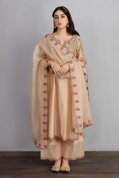 Beige long kurta with placement aari worked motifs and side slits. Comes with sheer panelled pants and silk organza dupatta.
Component: 3
Embroidered
Neckline: Round
Sleeve Length: Long
Fabric: Kurta and Pant: Handwoven Chanderi; Dupatta and Pant: Silk Organza; Kurta: Cotton Voile
Color: Beige
Side slits
Scallop cutwork
Split neck
Sheer panel - Aza Fashions Pakistani Kurta Pant Design, Cotton Party Wear Suits, Organza Kurta Designs, Silk Embroidery Suits, Pure Silk Suits, Organza Kurta, Beige Kurta, Beige Embroidery, Dupatta Style