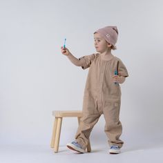 Say hello to our stylish Aneby children's short sleeve jumpsuit: a relaxed, contemporary piece featuring straight leg fit and charming upturned hems on both trousers and sleeves. Its round neck is nicely finished with smart binding, and it's kitted out with large 15mm popper fastenings from the neck opening down to the rise seam. This jumpsuit is the perfect outfit for your little explorer! Its comfy, roomy fit and simple front opening make it the ideal one-piece getup for those spontaneous adve Casual Solid Color Jumpsuits And Rompers For Playwear, Short Sleeve Cotton Jumpsuits For Playwear, Casual Short Sleeve Jumpsuit For Playwear, Casual Short Sleeve Jumpsuits And Rompers For Play, Short Sleeve Jumpsuit, Kids Overalls, Jumpsuit For Kids, Garment Pattern, Short Sleeve Jumpsuits