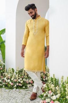 Yellow kurta with placed cutdana embroidered floral motifs. Comes with trouser.
Components: 2
Pattern: Embroidered
Type Of Work: Thread, Cutdana
Neckline: Mandarin Collar
Sleeve Type: Full
Fabric: Kurta: Cotton Blend, Trouser: Cotton Silk
Color: Yellow
Other Details: 
Closure: Kurta: Front button
Occasion: Sangeet,Mehendi and Puja - Aza Fashions Trouser Men, Trouser For Men, Plain Yellow, Yellow Kurta, Kurta Cotton, Floral Motifs, Mandarin Collar, Mens Trousers, Cotton Silk