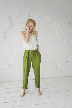 "DETAILS * Loose linen pants * With the elastic band around and two side pockets * Relaxed fit at the above and tapered bottomms * Made from soft wash medium weight (185 gsm) 100 % European linen fabric * Height of the model is 175 cm (5′ 9″) and she is wearing pants in size XS and natural gray stipes colors * Pants inner seam - 74 cm / 29.1''; pants outer seam - 106 cm / 41.7'' * Please choose another color and size on the right * Product number: P04 CARE LABEL * machine wash gentle (40 C/104 F Green Linen Harem Pants With Elastic Waistband, Green Linen Bottoms With Side Pockets, Relaxed Green Bottoms With Pockets, Flax Tapered Leg Pants With Pockets, Linen Pants With Tapered Leg And Pockets, Linen Pants With Pockets And Tapered Leg, Tapered Leg Linen Pants With Pockets, Everyday Green Pants With Elastic Waistband, Summer Linen Tapered Pants