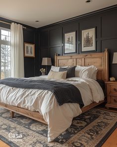 a bedroom with black walls and white bedding in front of a large glass window