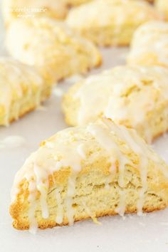 glazed scones with icing sitting on a white surface