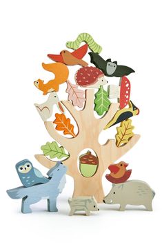 a wooden toy tree with animals and leaves