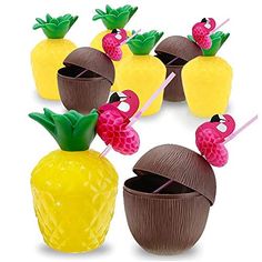 several pineapples and strawberries are placed on sticks in the shape of fruit