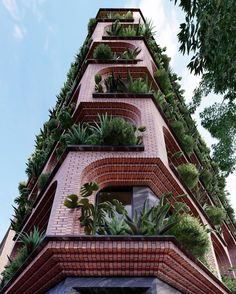 a tall brick building with plants growing on it