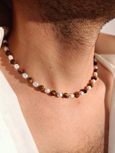 Mens pearl necklace, Tigers eye beaded y2k crystal choker, Surfer necklace, Boyfriend gift ideas, Real pearl y2k necklace men Pearls have long ceased to be in the arsenal of only women. Men easily complement their look with a classic string of pearls or a single pearl on a chain. It is not only fashionable and stylish, but also beautiful. Give this necklace to your boyfriend, believe me, he will not remain indifferent. I only use natural freshwater pearls so I don't have perfect identical round Mens Pearl Jewelry, Mens Beaded Necklace, Men Pearls, Cool Necklaces For Men, Masculine Necklace, Mens Pearl Necklace, Beaded Necklace For Men, Pearl Jewlery, Pearl Necklace Men