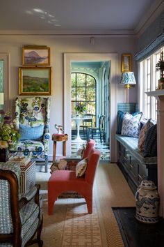 a living room filled with furniture next to a fire place under a painting on the wall